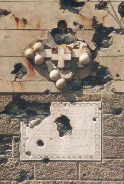 Cross of the order of St Maurice and St Lazarus on the wall of the hospice